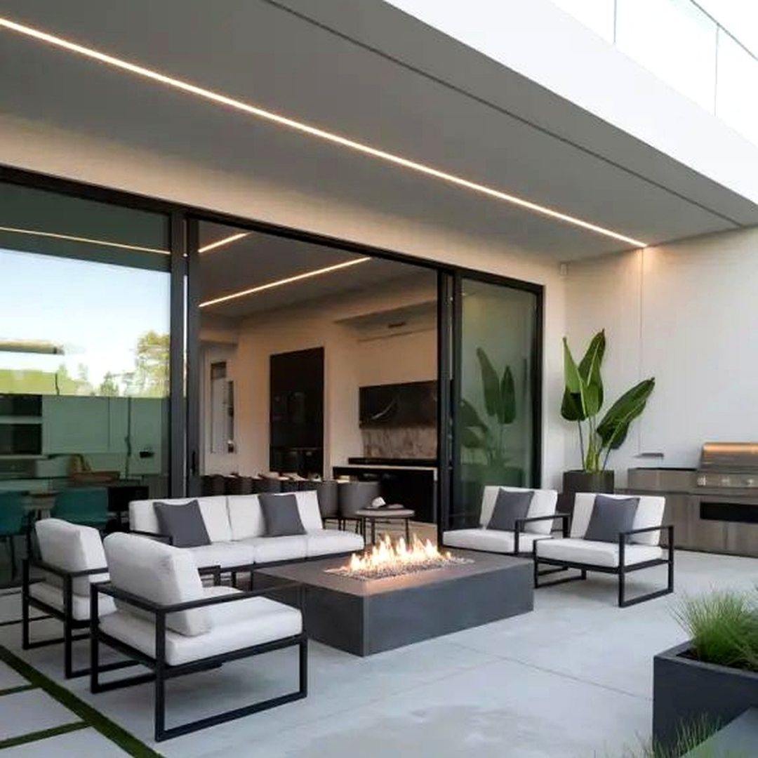 Modern patio with stylish seating, wooden deck, and ambient lighting