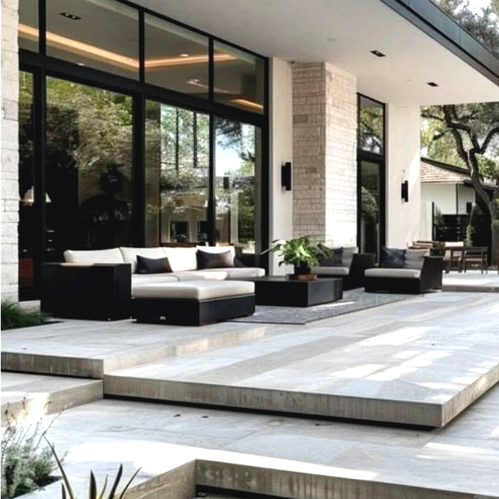 Modern luxury patio design featuring elegant outdoor seating, wooden decking, ambient lighting, lush greenery, and a stylish outdoor living space